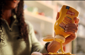 Woman squeezing a French's Mustard bottle