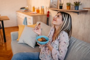 GettyImages-2261412797 woman enjoying cookies
